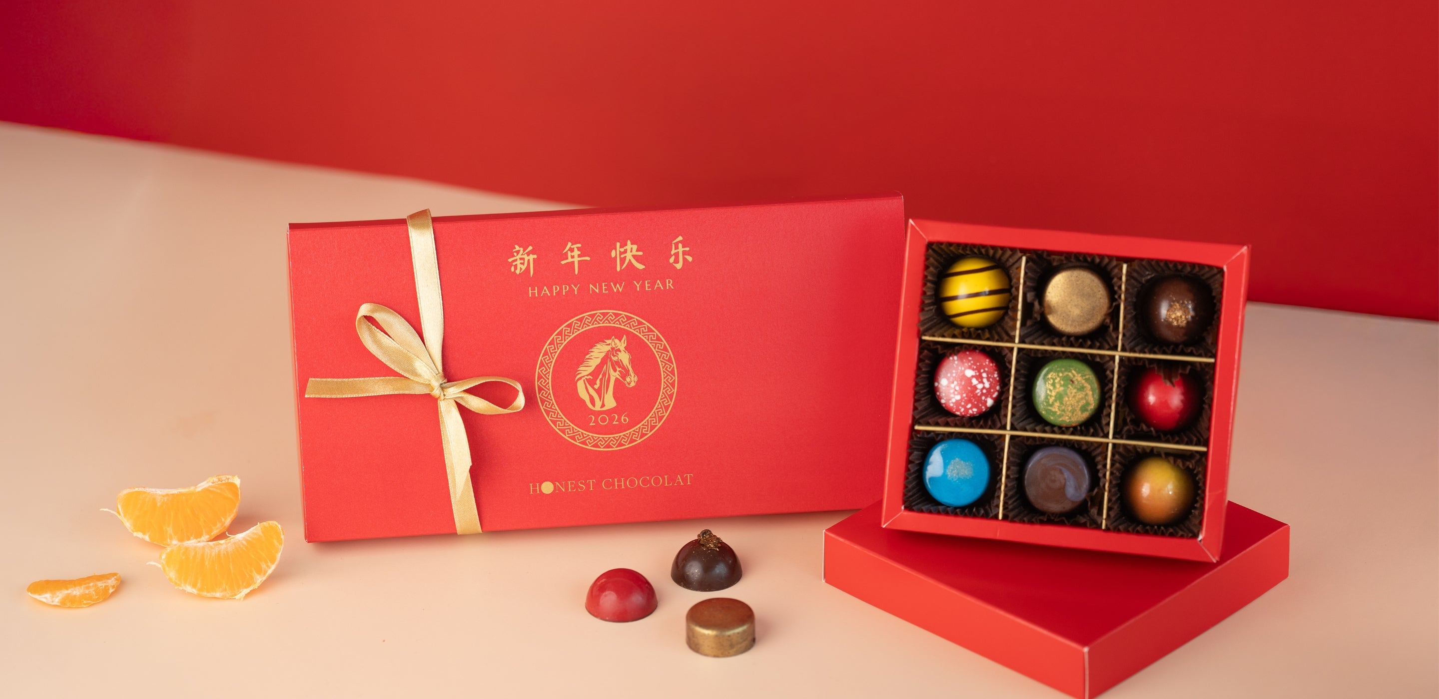 Chinese New Year red gift boxes with colorful chocolates and festive decorations.