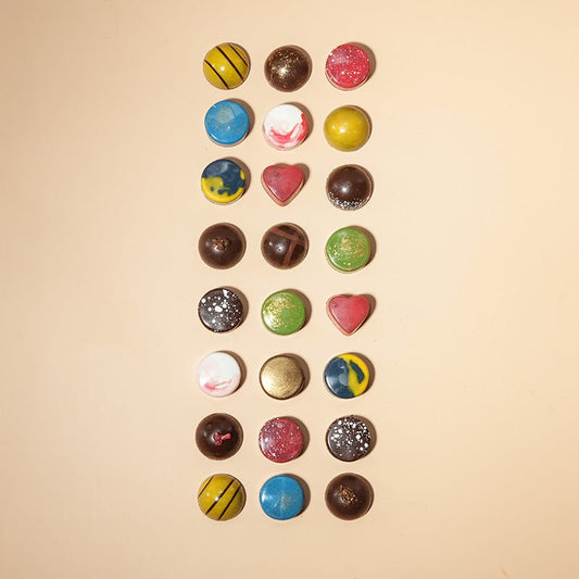 Assorted chocolate bonbons from Honest Chocolat, with each bonbon uniquely shaped and colored