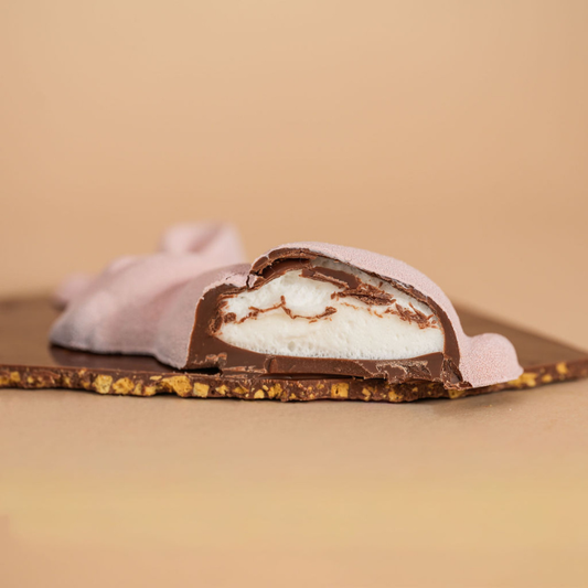 Chocolate-covered treat with a marshmallow center on a beige background