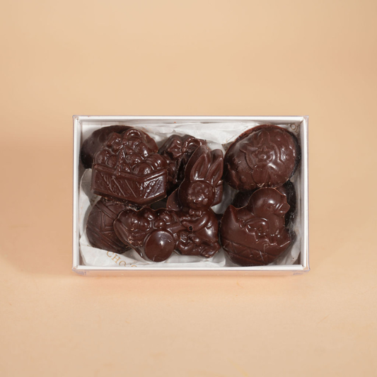 Box of chocolate candies with a beige background