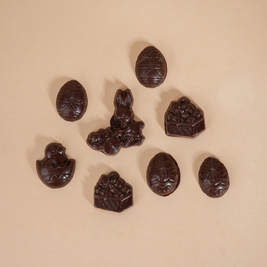 Assorted chocolate candies on a beige background