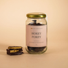 Jar of 'Hokey Pokey' chocolate with 'Honest Chocolat' label, on a warm beige background 