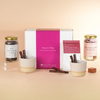 Hot chocolate gift set with a pink box labeled 'Hug in a Mug' on a beige background.