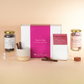 Hot chocolate gift set with a pink box labeled 'Hug in a Mug' on a beige background.