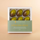 Box of Honest Chocolat Pistachio Eggs on a beige background