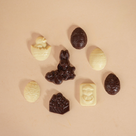 Assorted chocolate candies on a beige background
