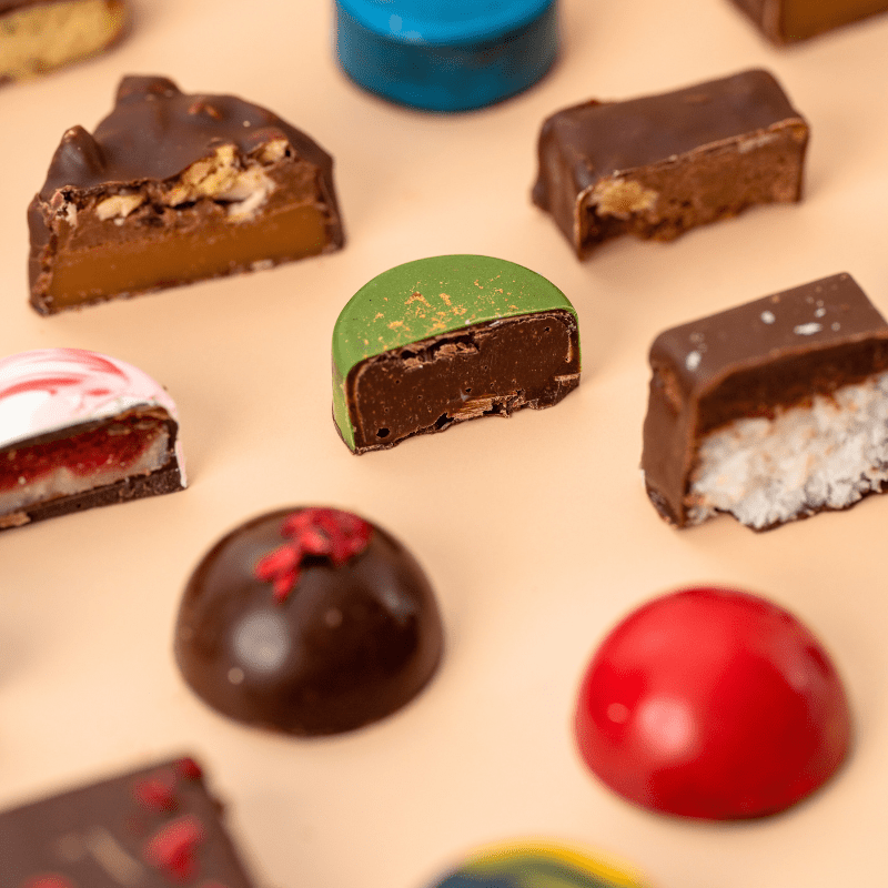 Close-up of handcrafted artisan chocolates inside the Honest Chocolat Christmas Advent Calendar, premium gift for chocolate lovers.