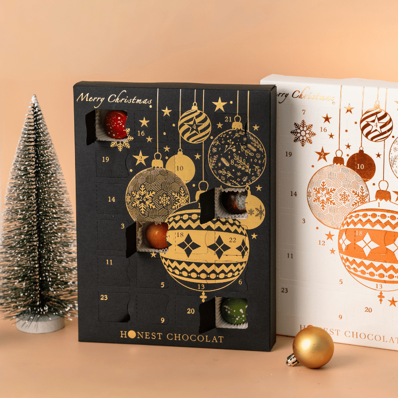 Side profile of Honest Chocolat Collector’s pair of Christmas Chocolate Advent Calendars, luxury black and gold and white and bronze editions handmade in New Zealand.